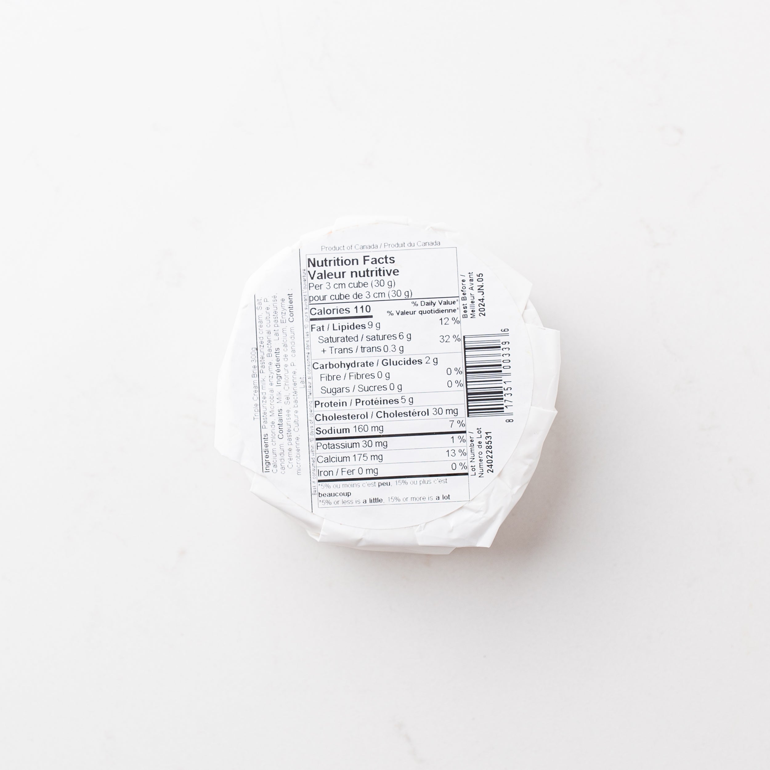 A block of cheese on a plain white background.