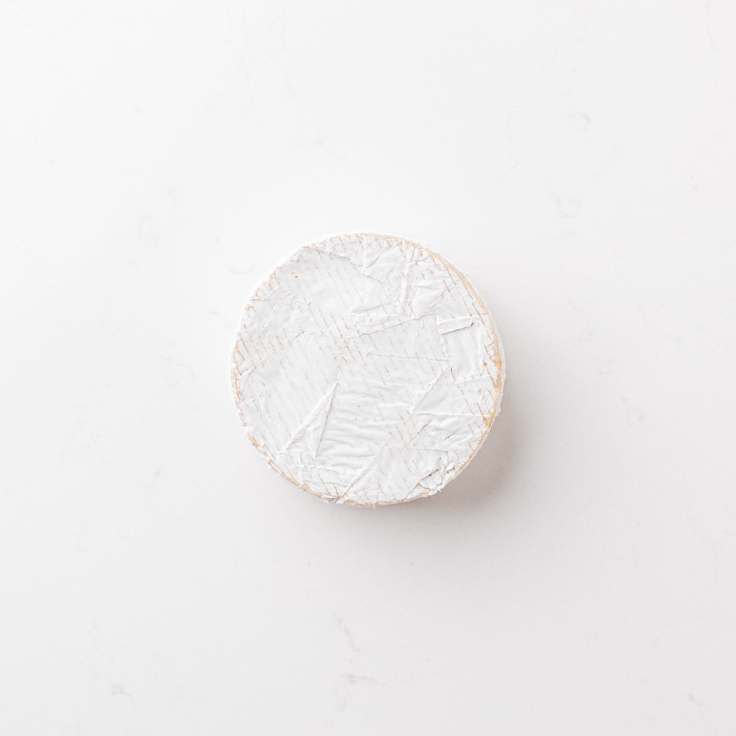A block of cheese on a plain white background.