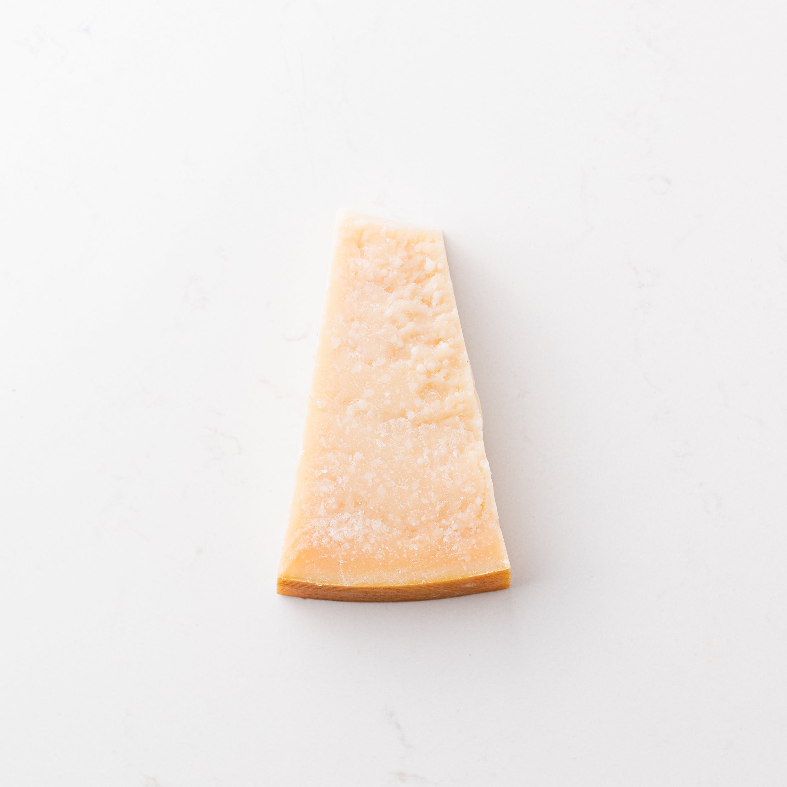 A block of cheese on a plain white background.