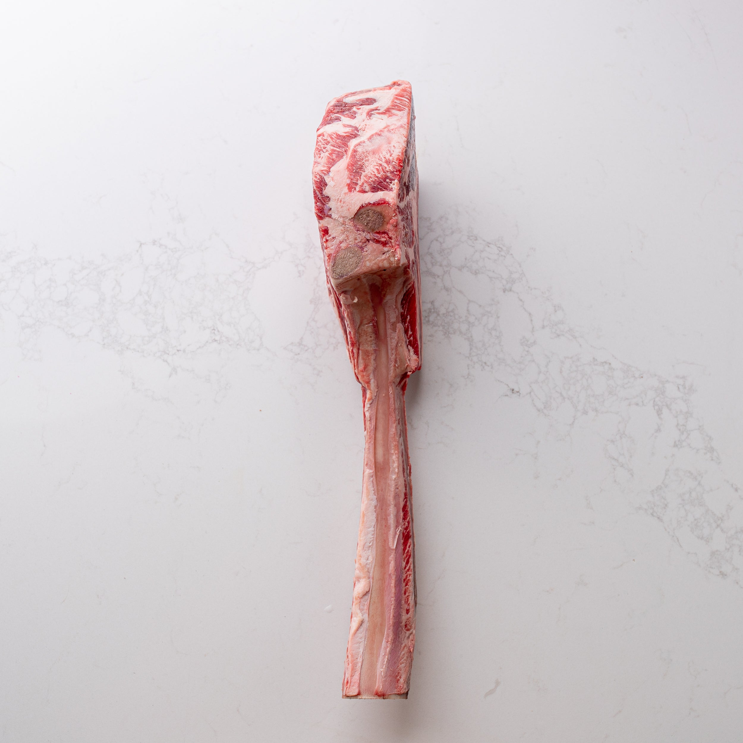 An appealing sight of a natural and locally sourced tomahawk steak, labeled as number 5, showcased at The Butcher Shoppe.