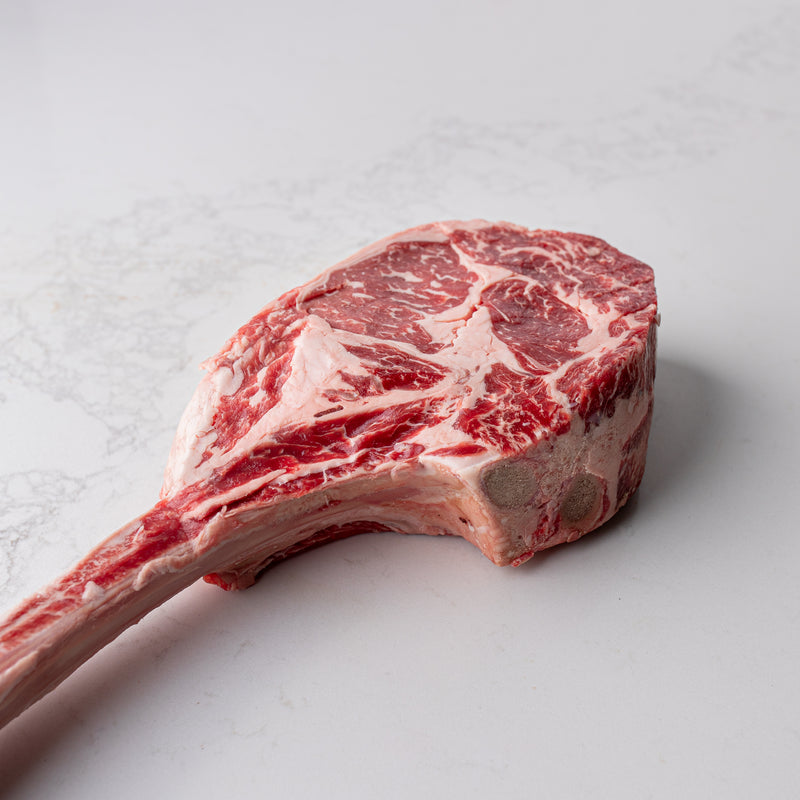 An inviting view of a natural and locally sourced tomahawk steak, numbered 6, displayed at The Butcher Shoppe.