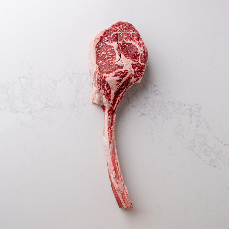 An image of a locally sourced, natural tomahawk steak featured at The Butcher Shoppe, known for its impressive size and quality.