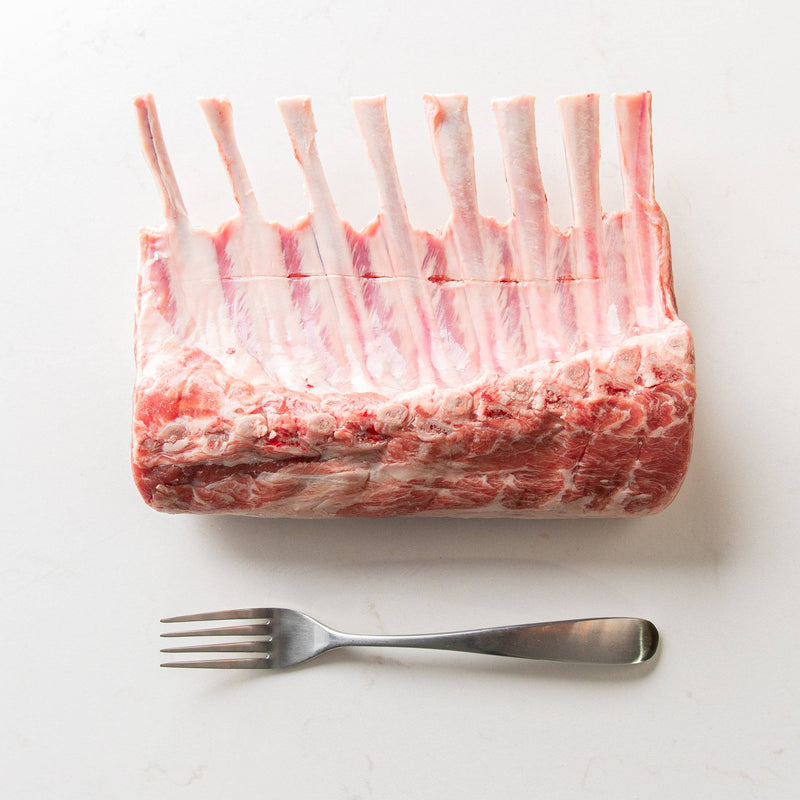 Canadian Frenched Rack of Lamb Beside a Fork for Comparison